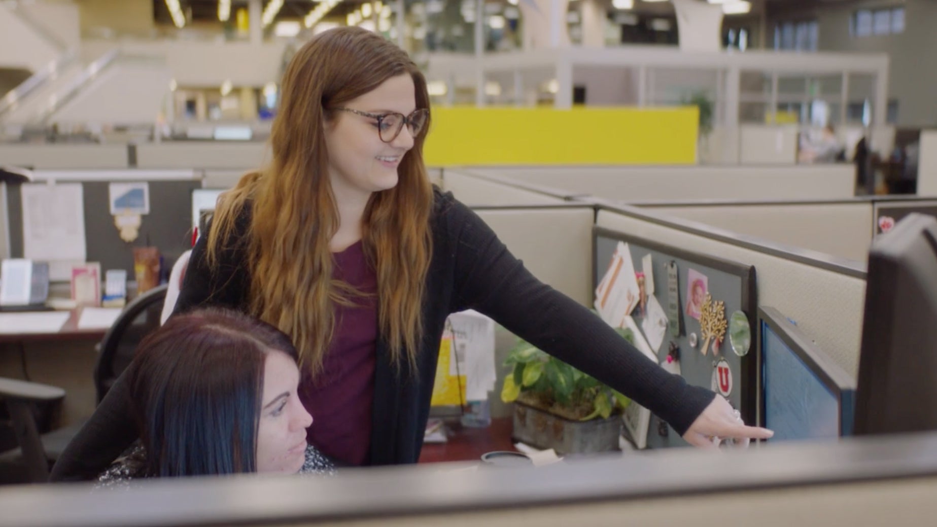 Woman pointing to computer screen