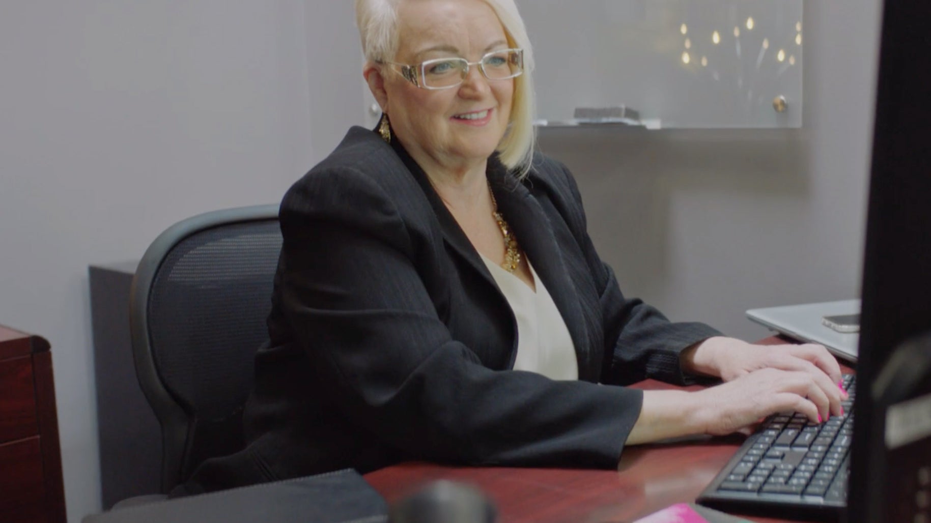 Woman typing on a computer