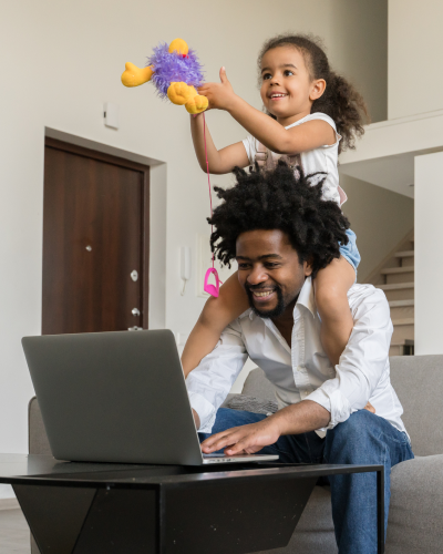 Dad working from home with daughter on his shoulders
