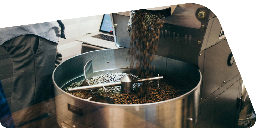 Image of coffee beans pouring into a roaster