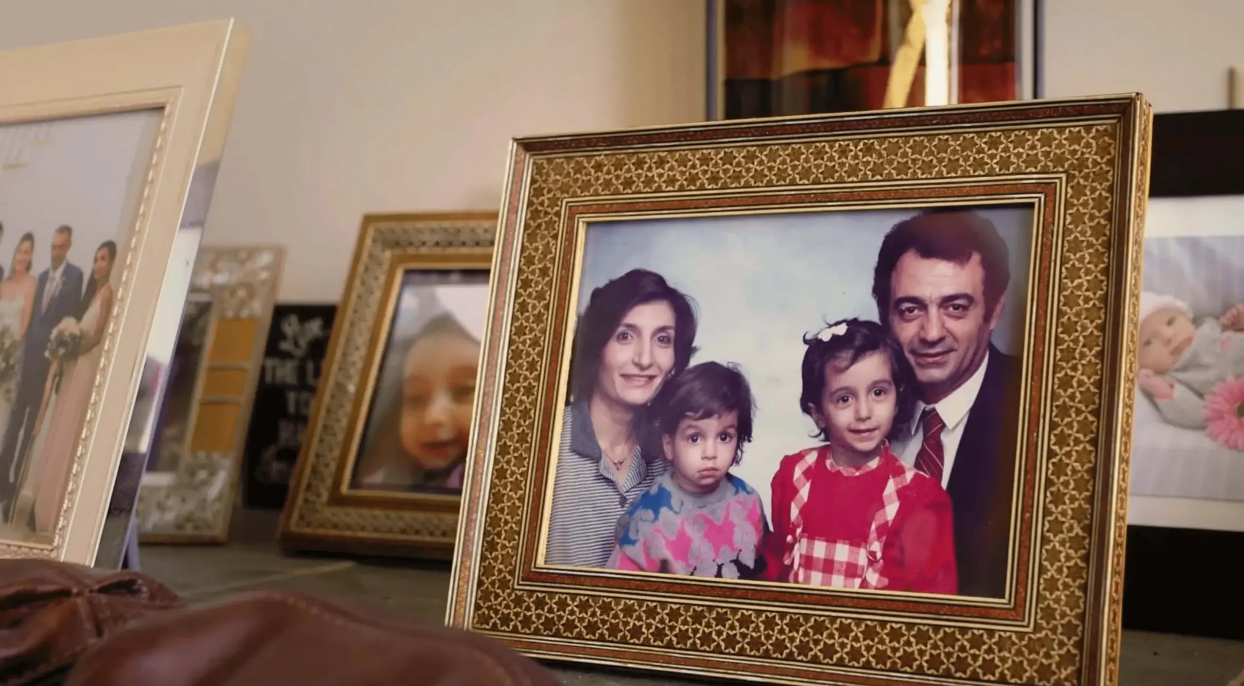 Gold frame containing photo of Nima Ghamsari's family