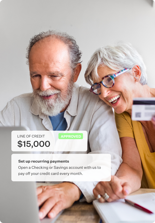 Image of a retirement age couple looking at laptop screen with partial product screen overlay showing that they are approve for a $15,000 line of credit.