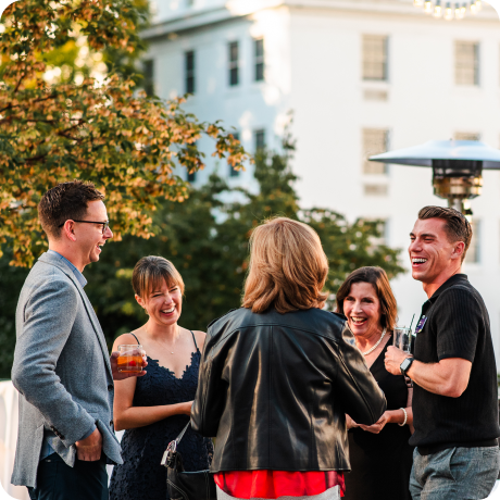 Group of 5 people standing and laughing