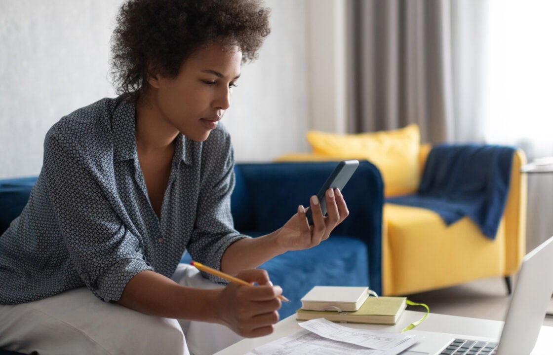 A woman rreviews mortgage application details together on a laptop.